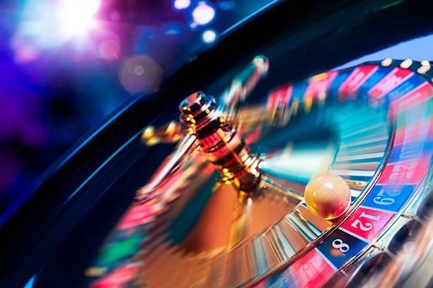 Live dealer dealing cards at baccarat table